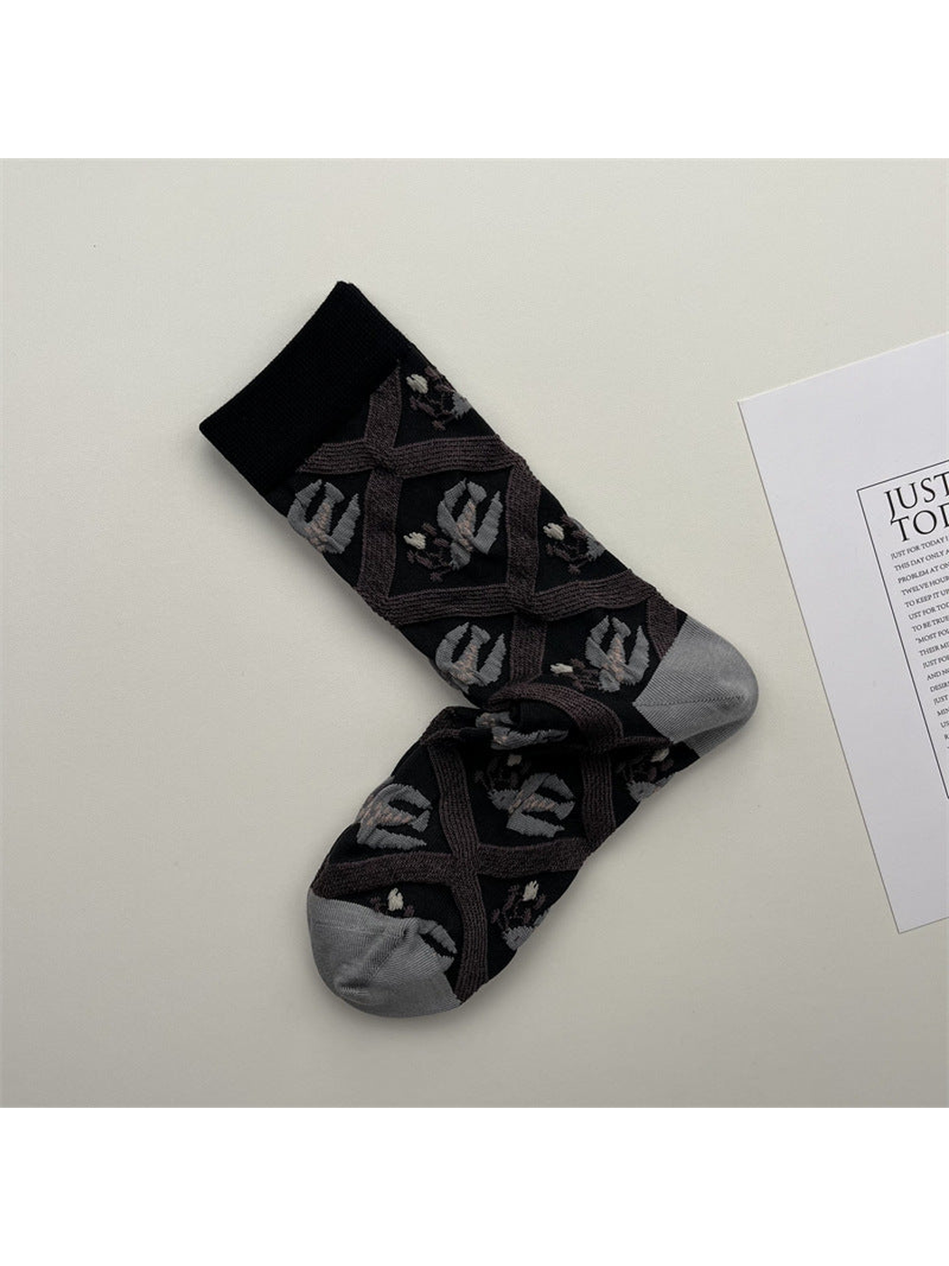 Black crew socks with mauve lattice bands and gray leaf motifs