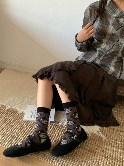 Leaf-lattice crew socks worn with black strap flats