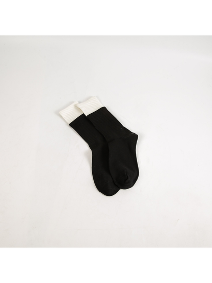 Black crew socks with contrasting white ribbed cuffs