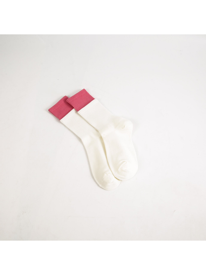 White crew socks with contrasting pink ribbed cuffs
