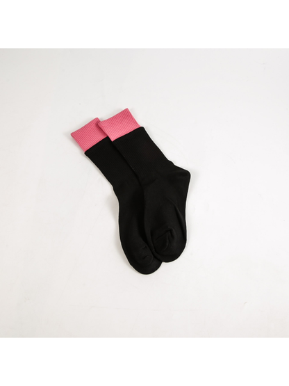 Black crew socks with contrasting pink ribbed cuffs