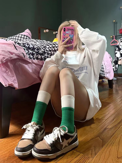 Green and white crew socks styled with sneakers