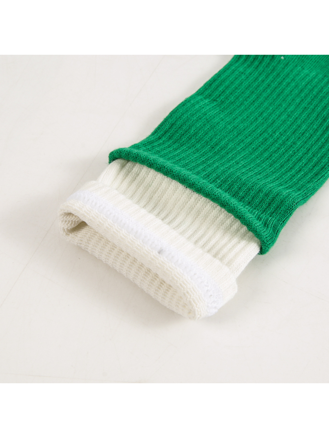 Close-up of the green ribbed leg and layered white cuff
