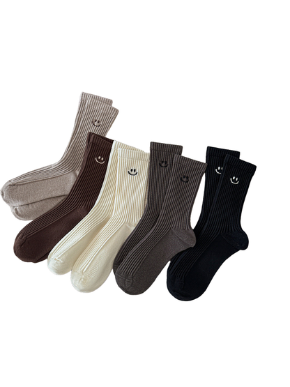 Five color variants of ribbed smiley crew socks arranged together