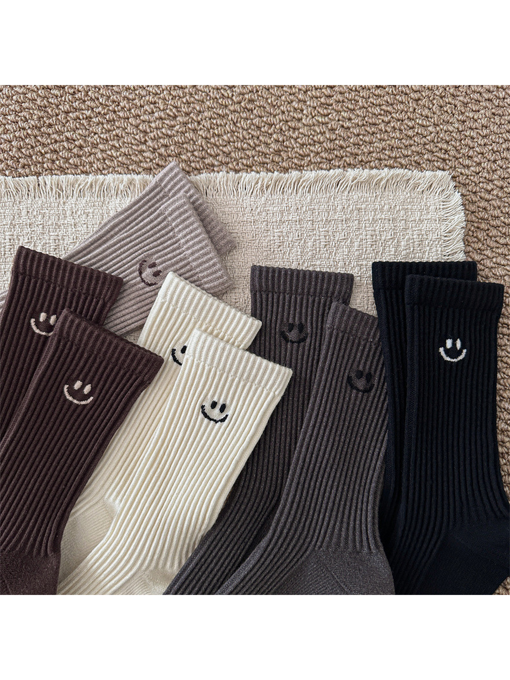 Close-up of contrasting smiley motifs on the five ribbed sock colors
