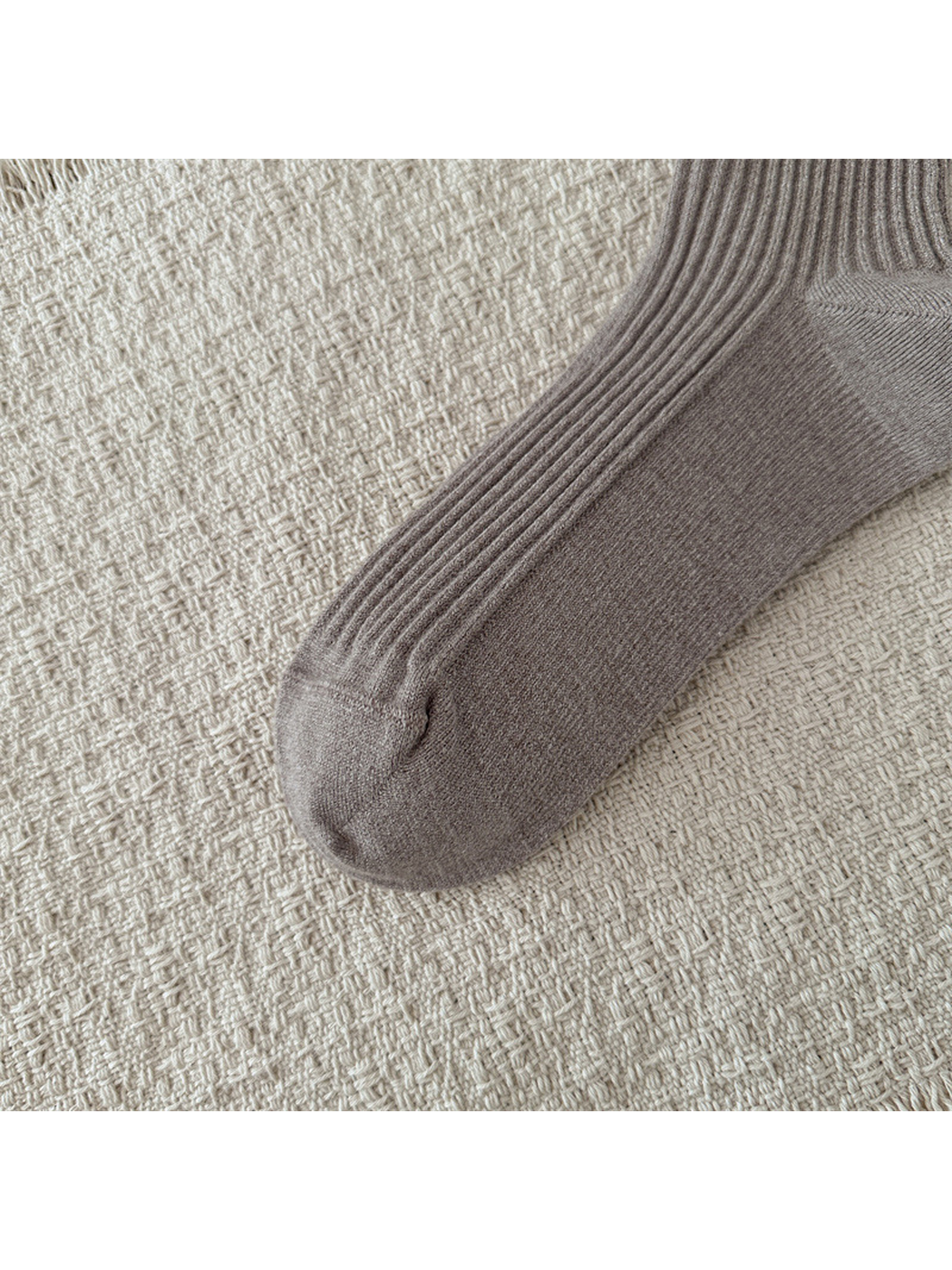Close-up of ribbing extending across the foot to the rounded toe seam