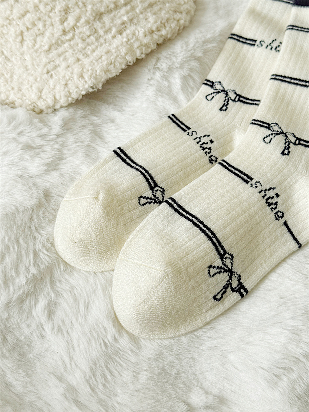 Close-up of the ivory sock toes and repeating bow pattern