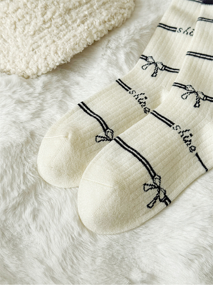 Close-up of the ivory sock toes and repeating bow pattern