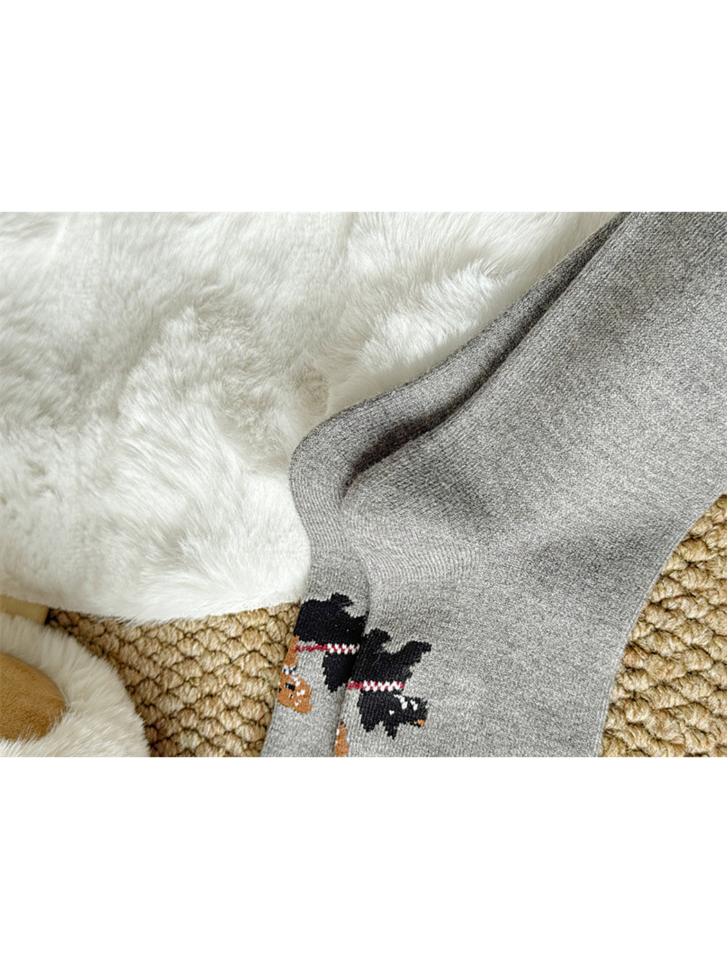 Close-up of the knit-in dog-walking graphic on gray socks