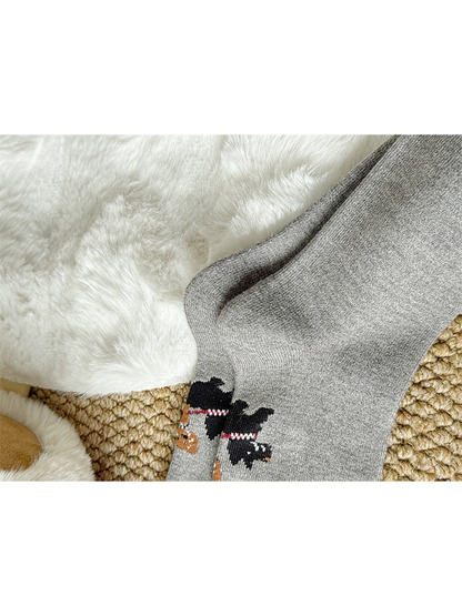 Close-up of the knit-in dog-walking graphic on gray socks