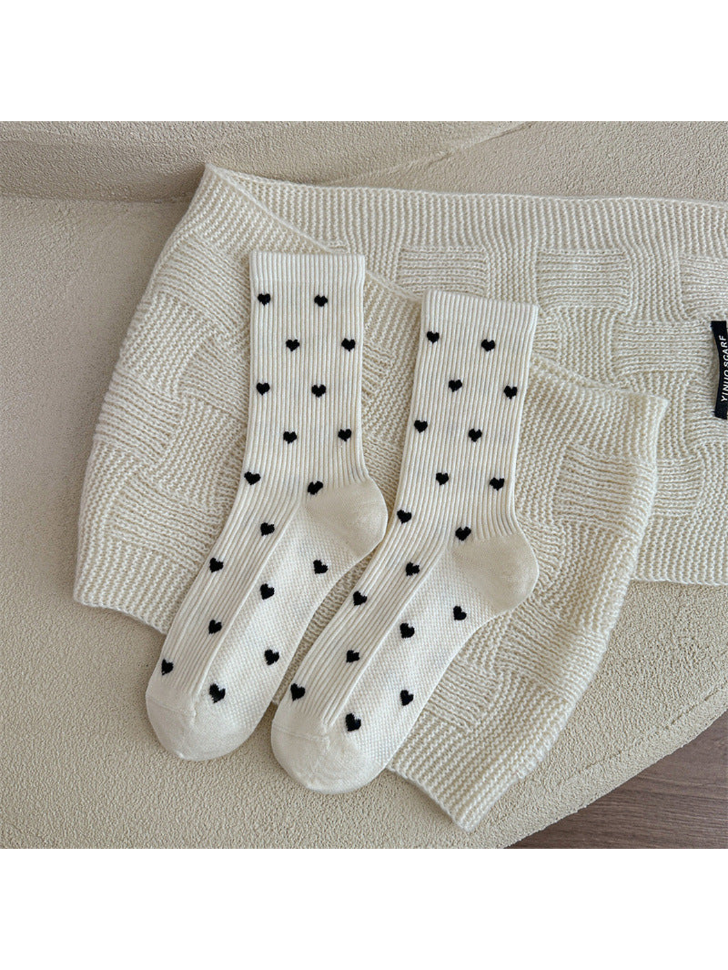 Ivory heart-pattern crew socks displayed as a pair