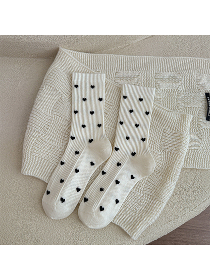 Ivory heart-pattern crew socks displayed as a pair
