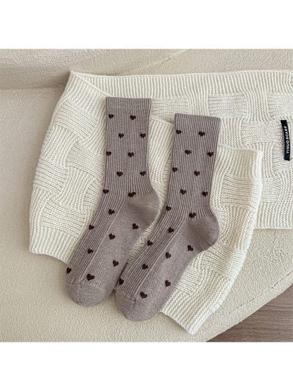 Greige heart-pattern crew socks displayed as a pair