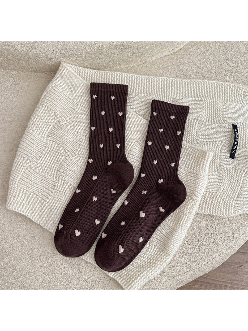 Dark brown heart-pattern crew socks displayed as a pair