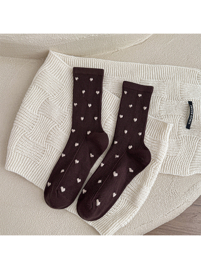 Dark brown heart-pattern crew socks displayed as a pair