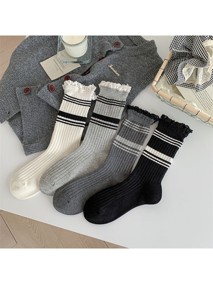 Four color variants of ribbed striped crew socks with lace-trimmed cuffs