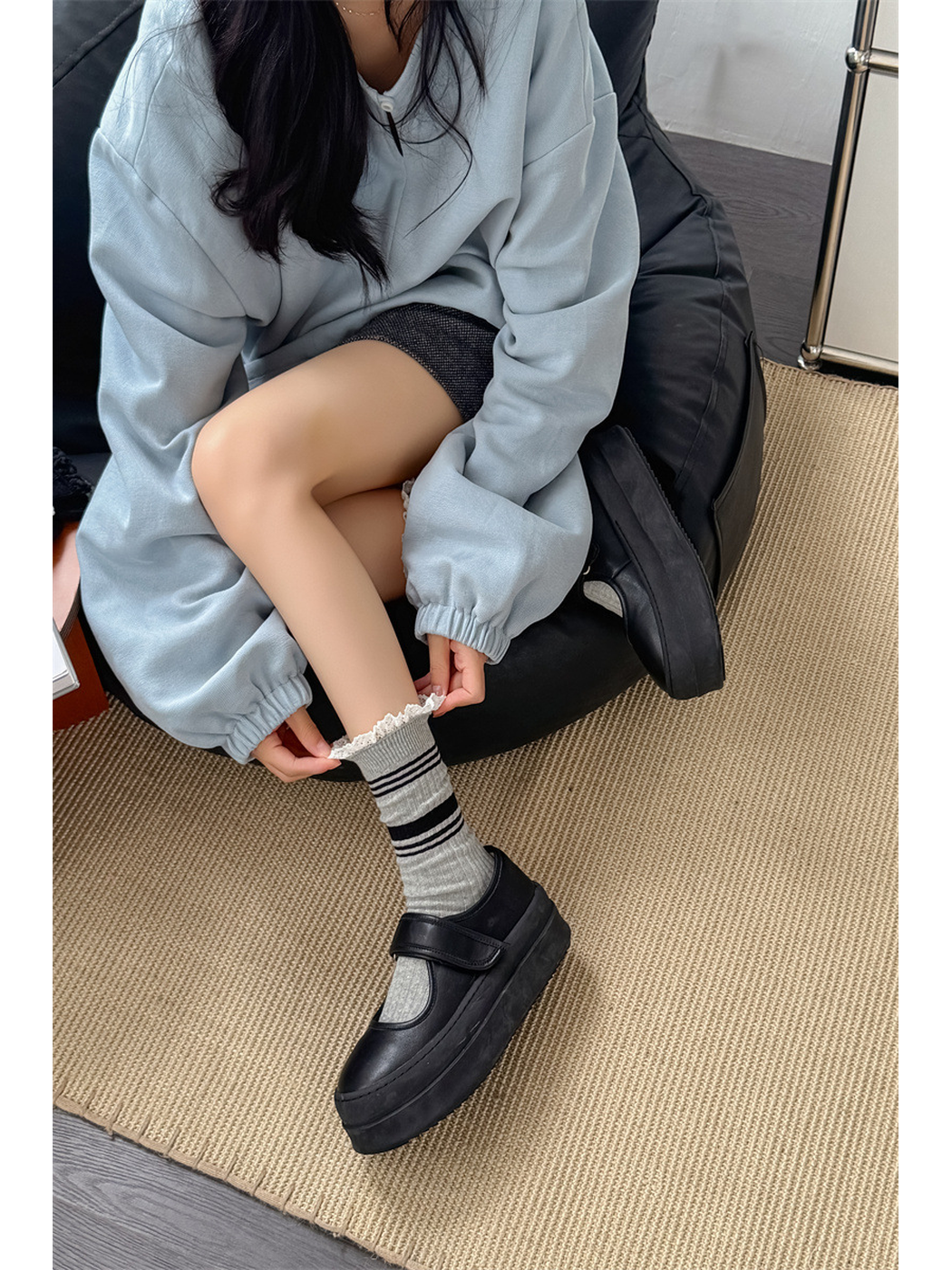 Light gray striped crew socks worn with black Mary Jane shoes