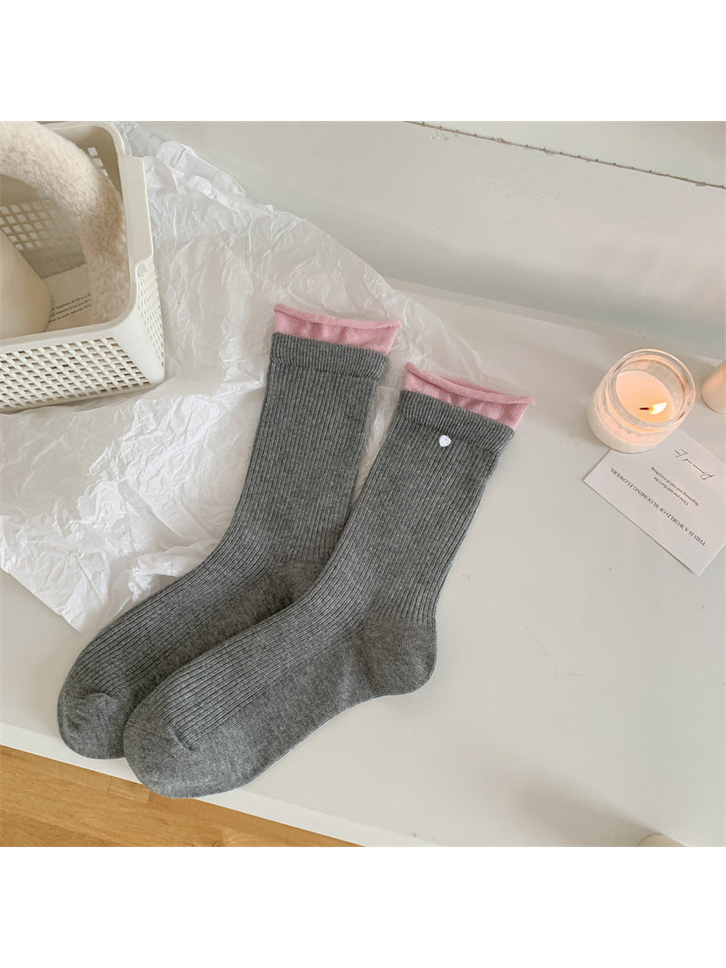 Gray ribbed crew socks with pink inner cuffs and a white dot accent