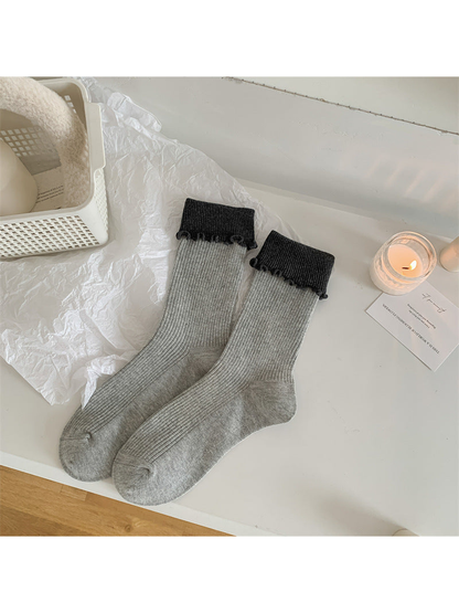 Light gray ribbed crew socks with dark folded ruffle cuffs
