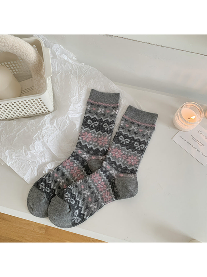 Gray crew socks with repeating pink, white and charcoal floral bands