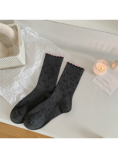 Dark gray textured crew socks with narrow pink scalloped trim