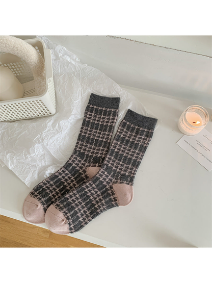Gray and pink plaid crew socks with pale pink toes and heels