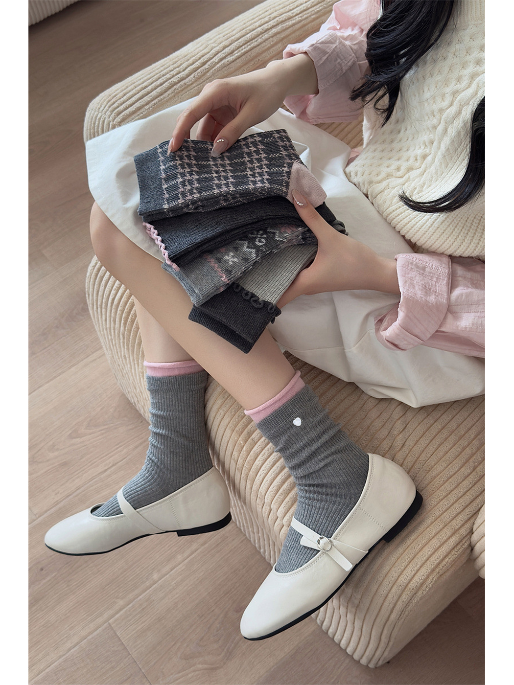 Gray ribbed socks with pink inner cuffs styled with white Mary Jane shoes