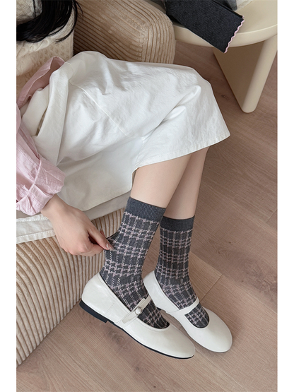 Gray and pink plaid crew socks styled with white Mary Jane shoes