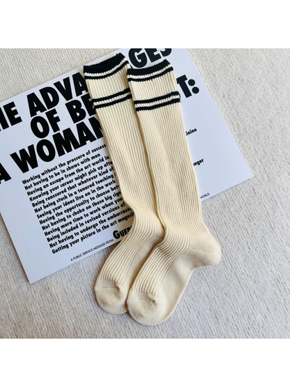 Ivory ribbed knee-high socks with black cuff and shaft stripes