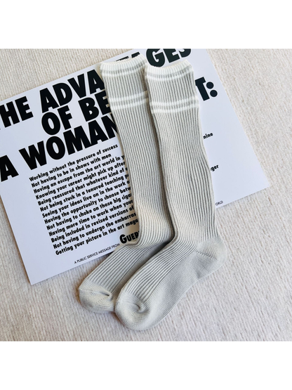 Light gray ribbed knee-high socks with white and gray stripes