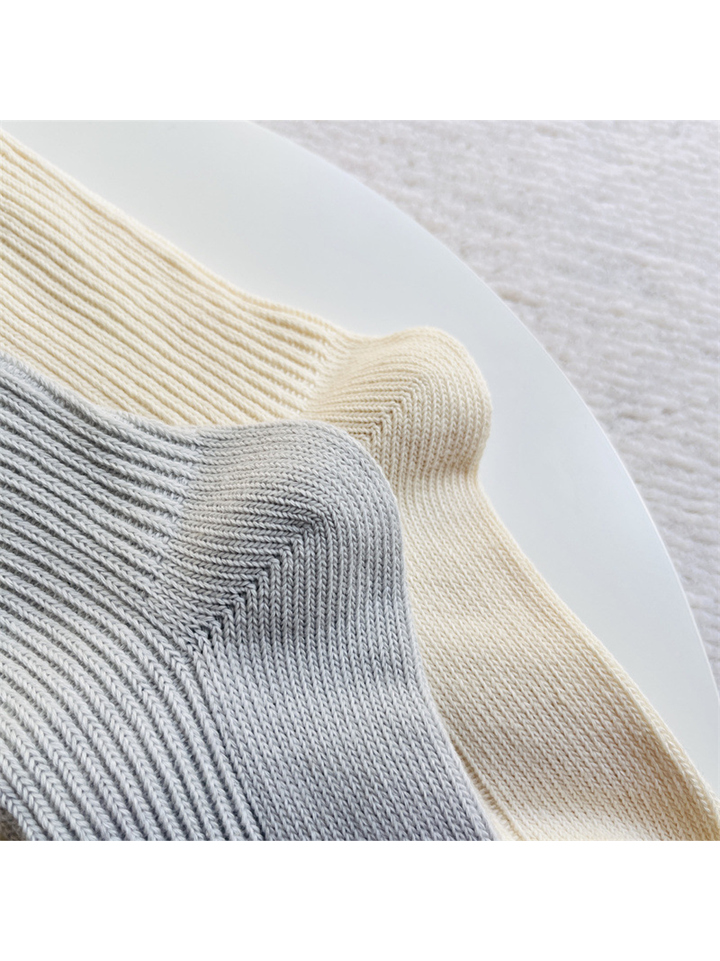 Close-up of the ribbed sock shafts curving around the shaped heels