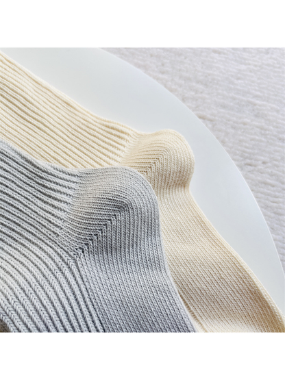 Close-up of the ribbed sock shafts curving around the shaped heels
