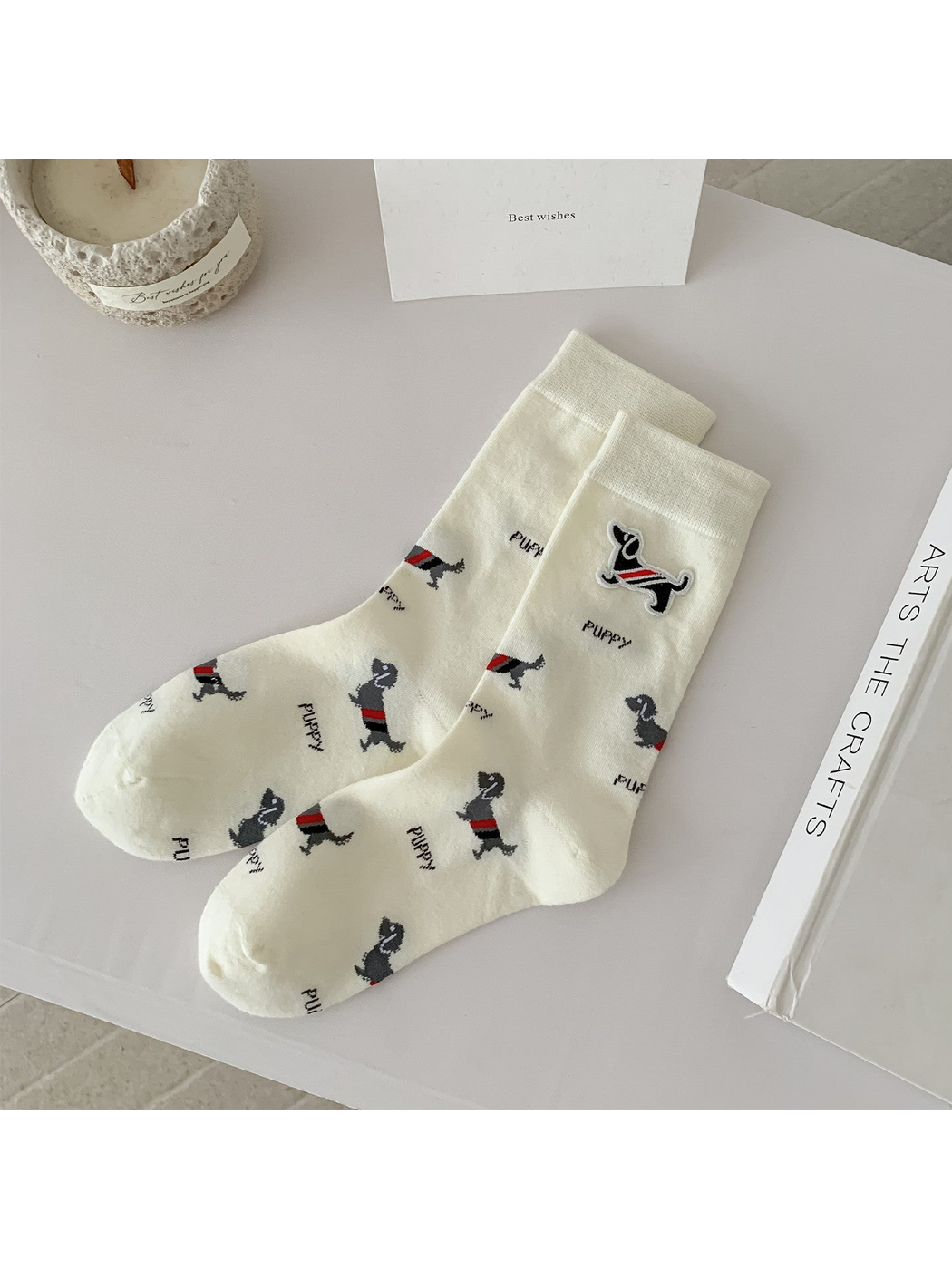 Ivory crew socks with dog motifs, lettering and a raised dog patch