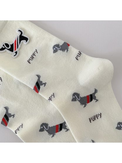 Close-up of the dog and lettering pattern across the ivory socks