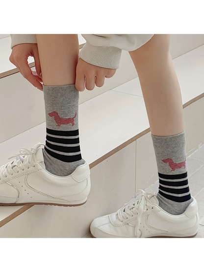 Light gray striped dog crew socks worn with white low-top sneakers