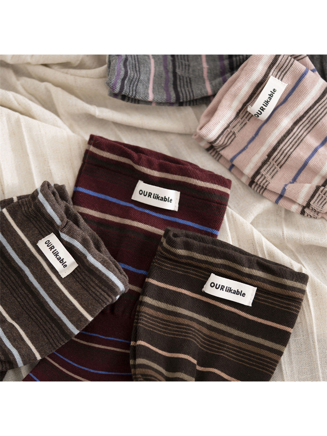 Five striped sock colors arranged together in folded close-up views