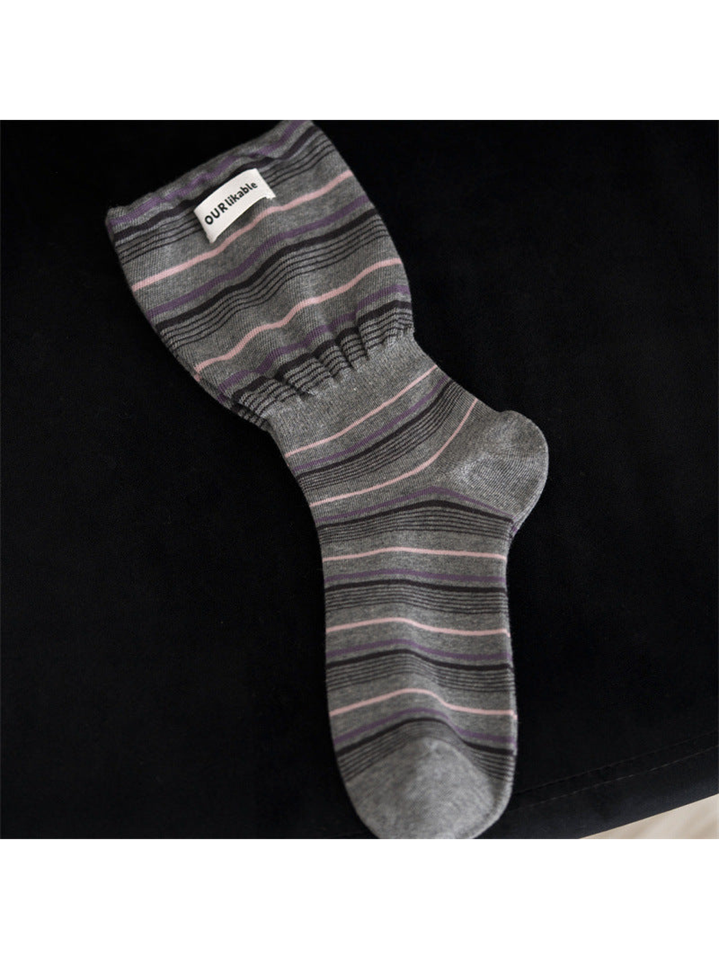 Gray striped crew sock with a gathered ankle band
