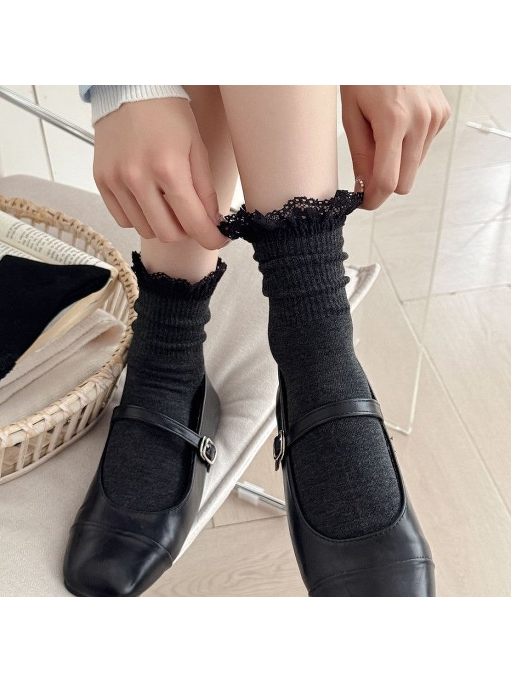Black lace-trim crew socks worn with black Mary Jane shoes