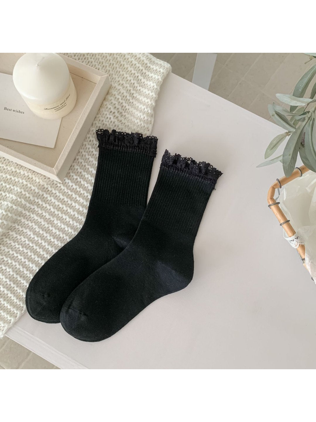Black crew socks with black lace-trim cuffs, full pair view