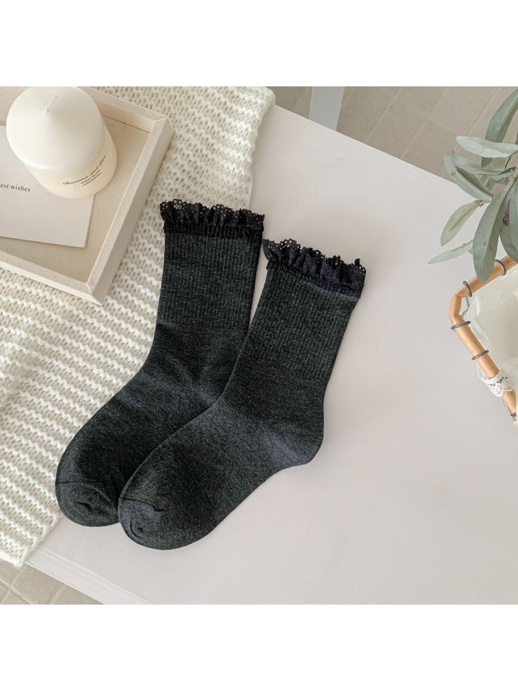 Dark gray crew socks with black lace-trim cuffs, full pair view