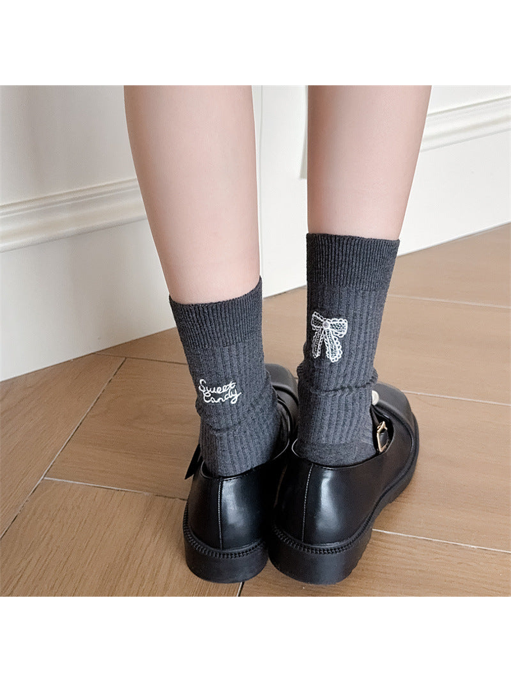 Dark gray ribbed crew socks worn with black shoes, rear view