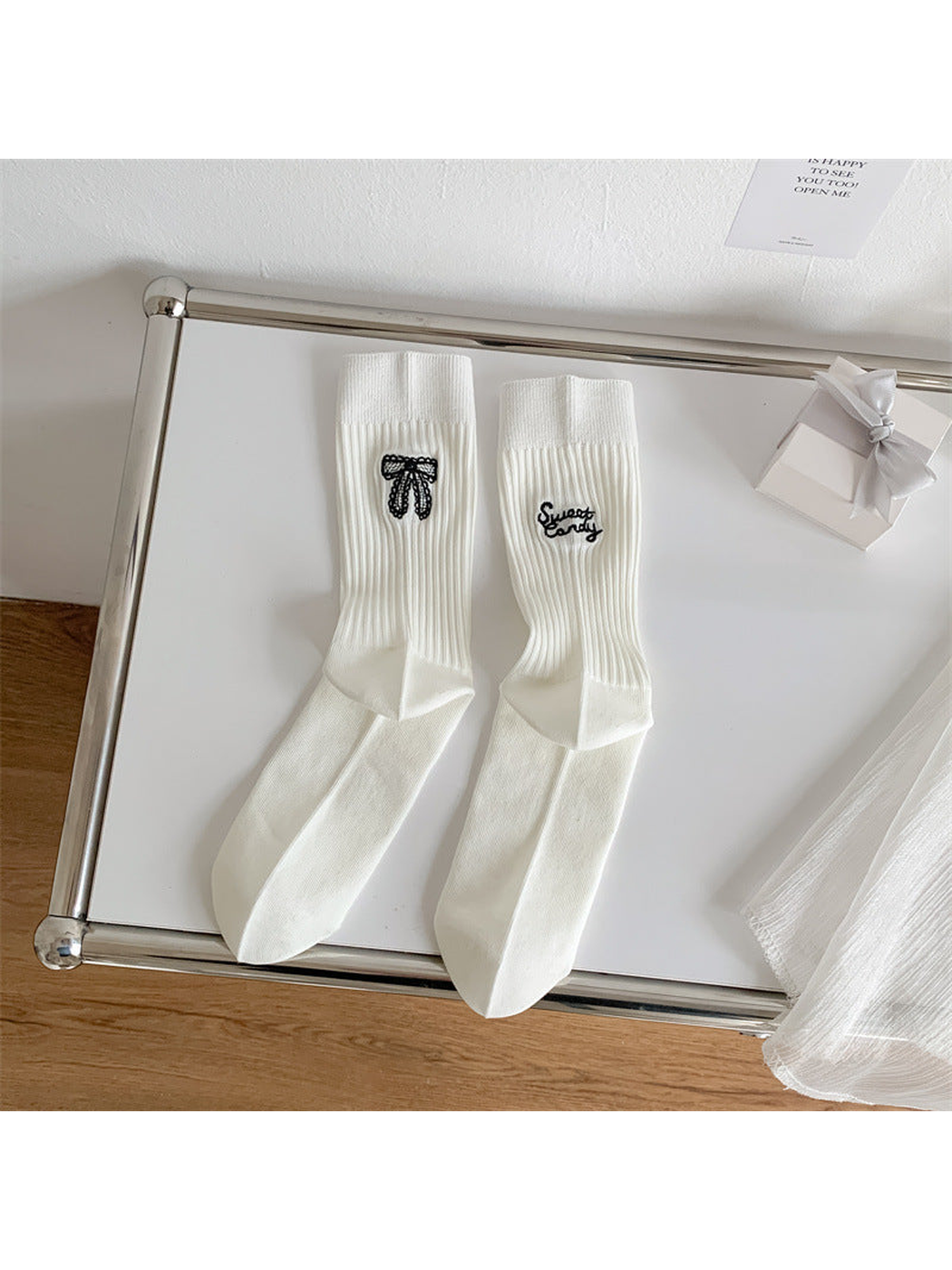 Ivory ribbed crew socks with black bow and script embroidery