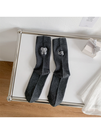 Dark gray ribbed crew socks with white bow and script embroidery