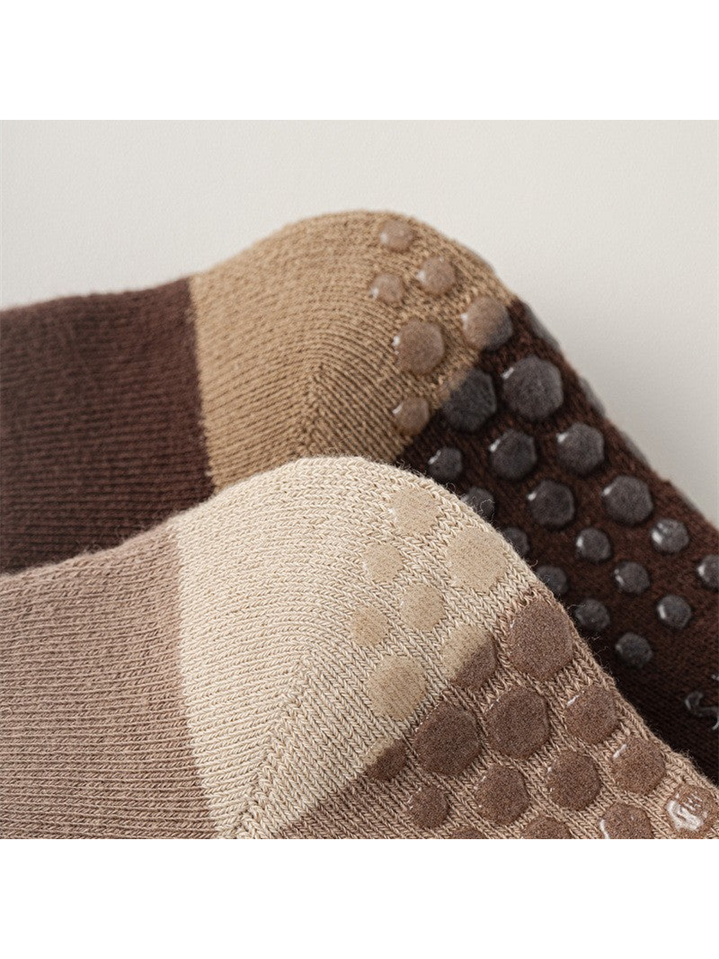 Close-up of the raised dot pattern across two sock soles