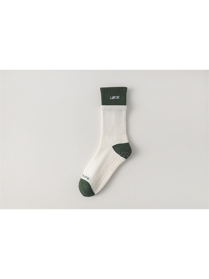 Ivory crew sock with dark green cuff, toe and heel, flat view