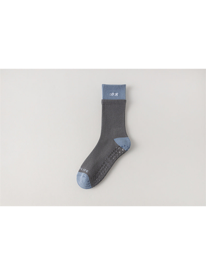 Dark gray crew sock with light blue cuff, toe and heel, flat view