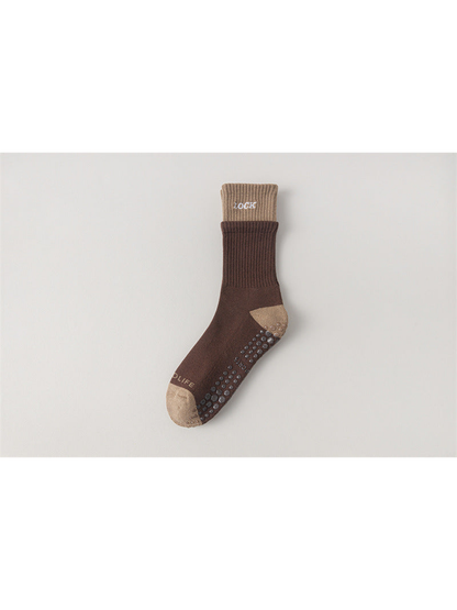 Dark brown crew sock with camel cuff, toe and heel, flat view
