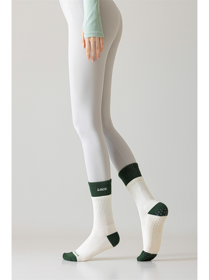 Ivory and dark green crew socks worn with one sole raised