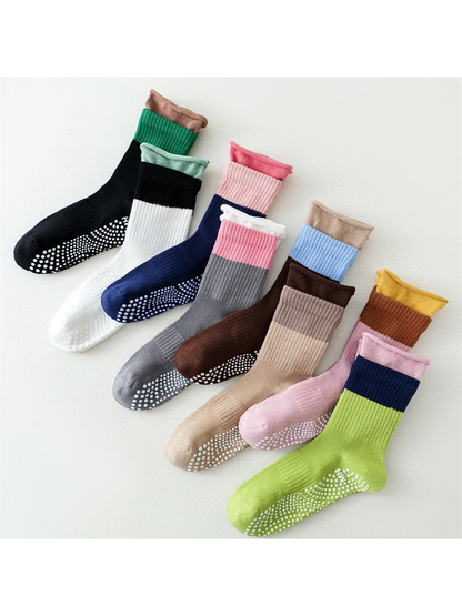 Color-blocked crew socks in eight colors with dotted soles