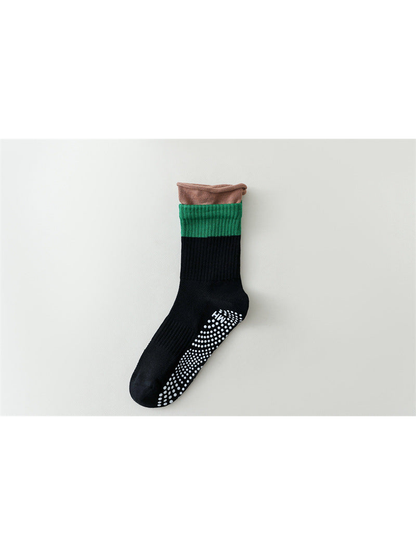 Black color-blocked crew sock with green band and brown rolled edge